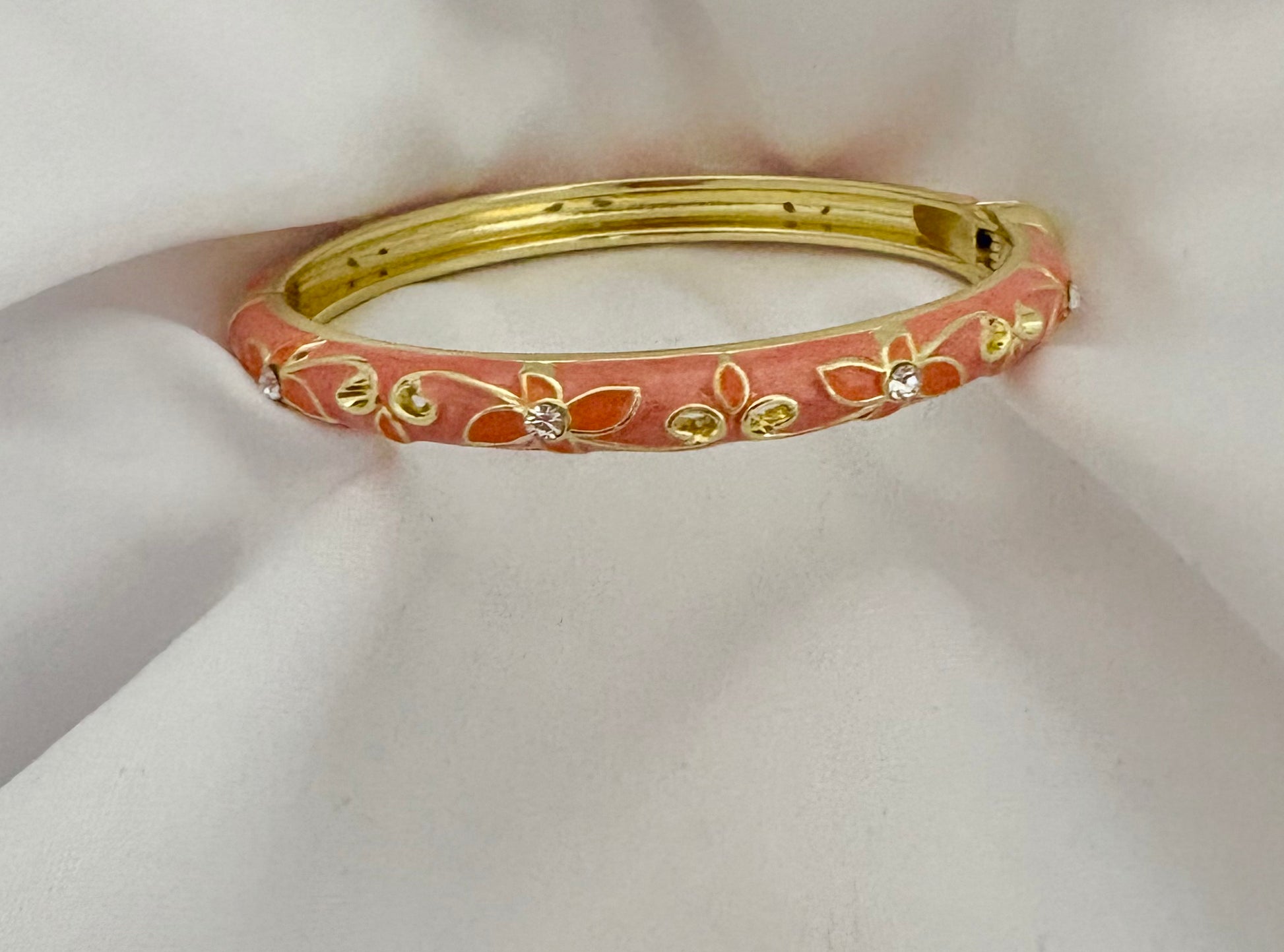Pink enamel floral bangle with 18K gold plated stainless steel and crystal accents