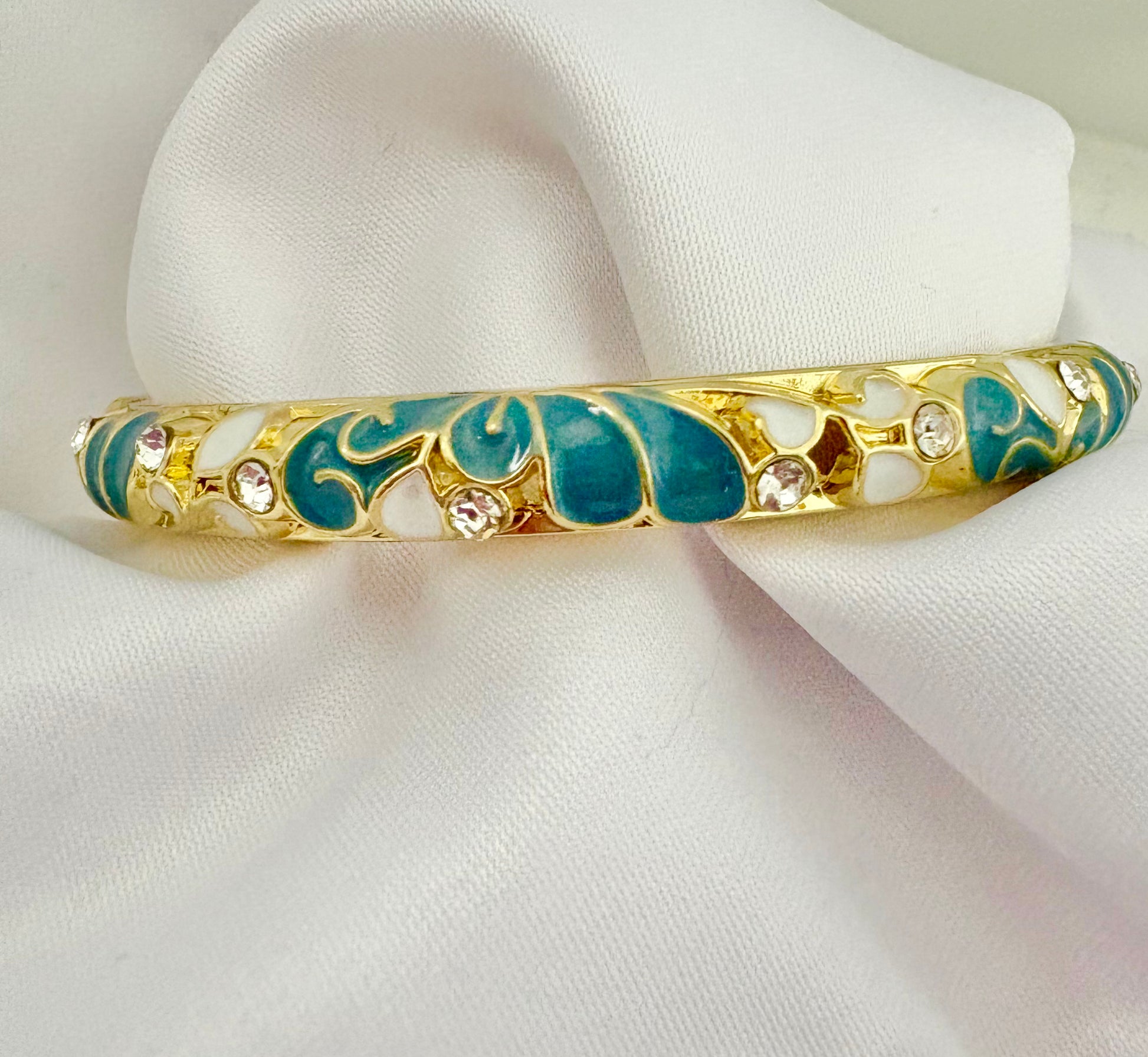 Waterproof hypoallergenic blue enamel bangle featuring floral details and gold finish