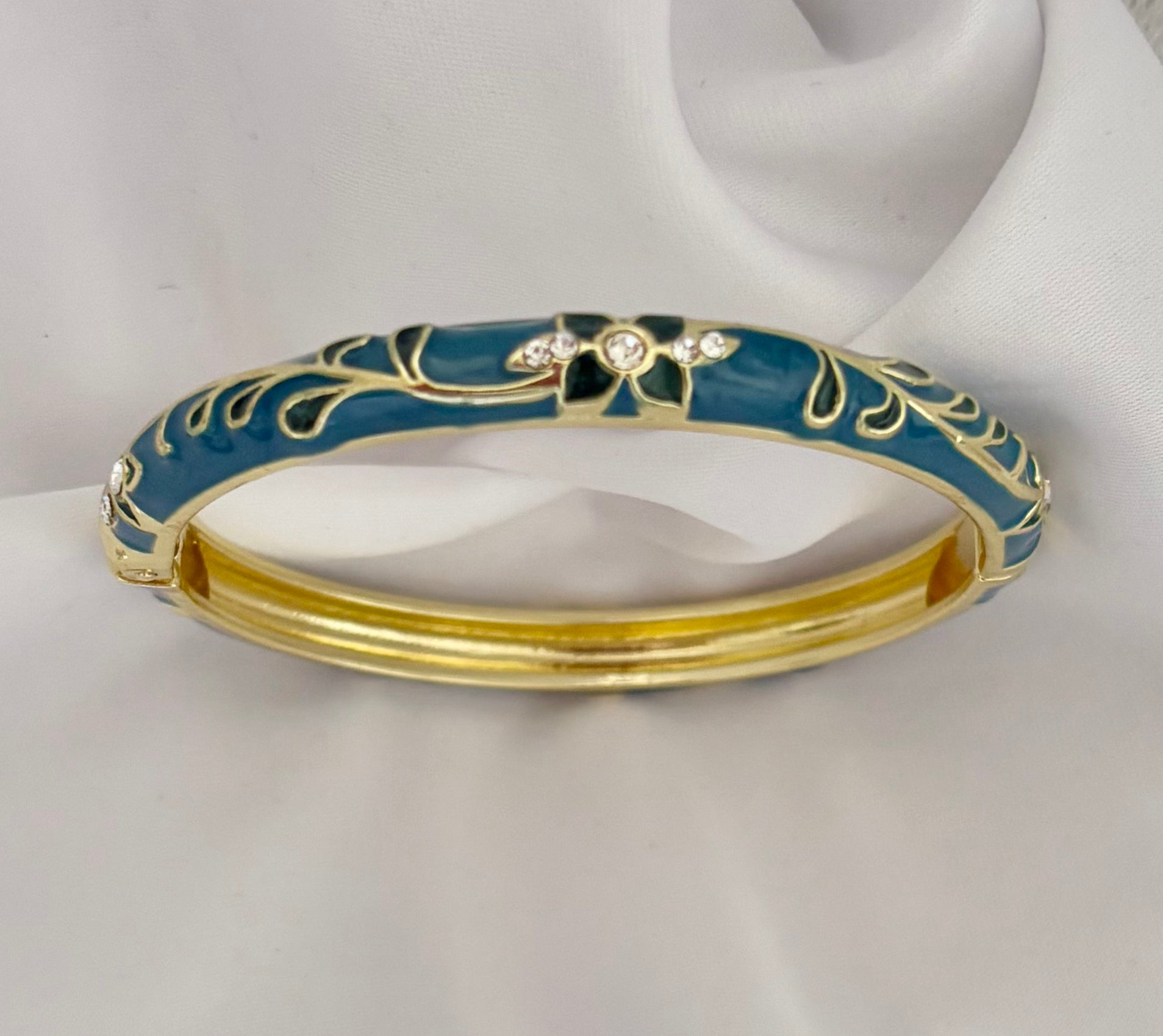 Elegant dark green bracelet with gold floral design and crystal accents