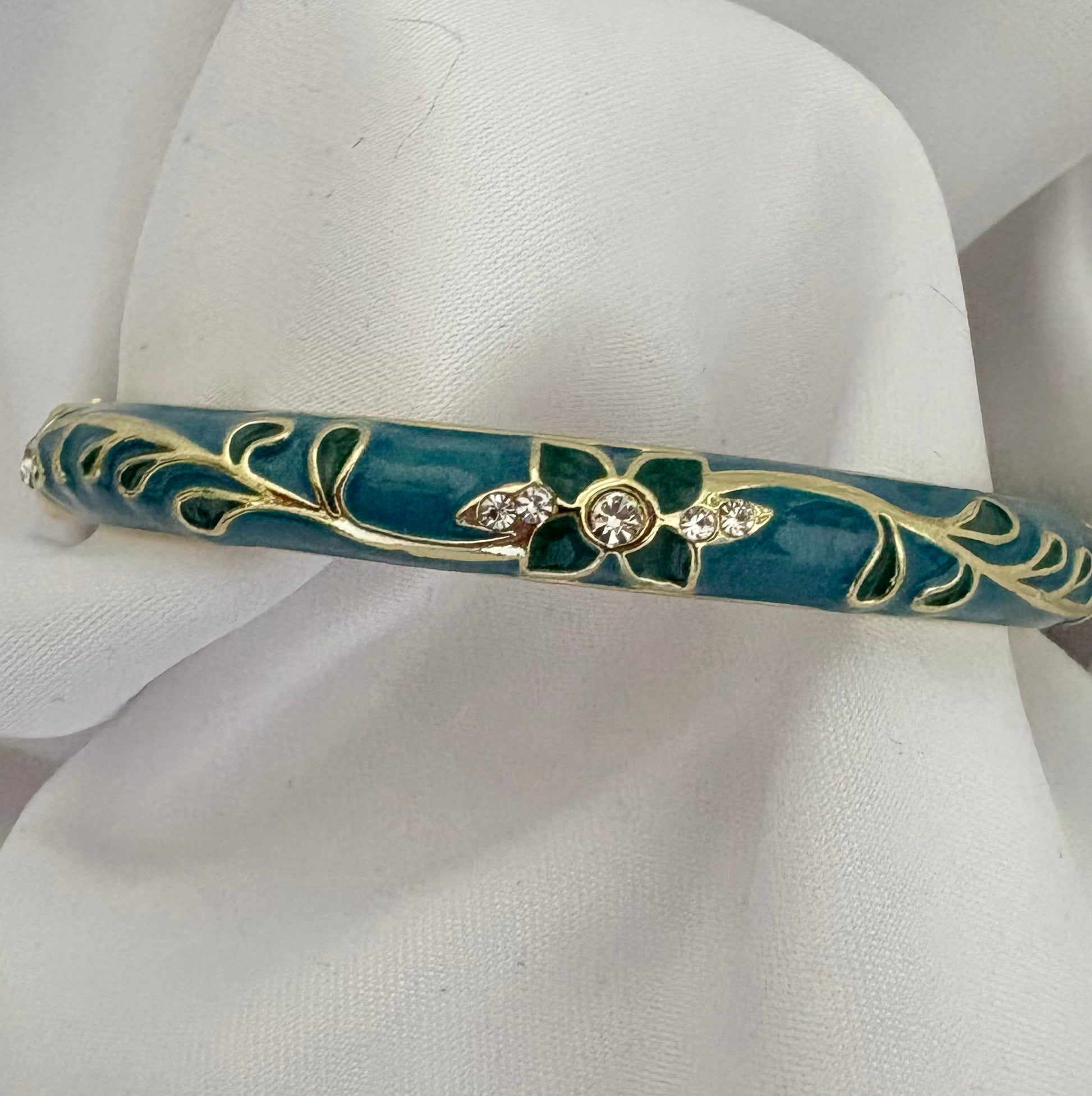 Gold plated stainless steel green enamel bangle with floral details