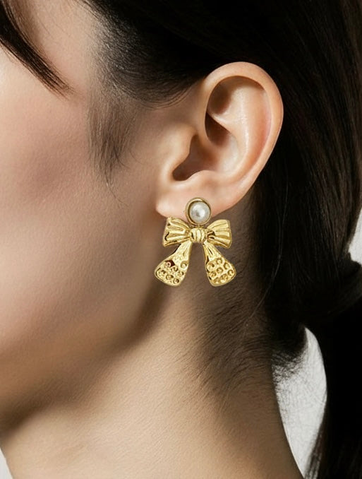 Gold bow-shaped drop earrings with pearl top, 3cm by 3.5cm