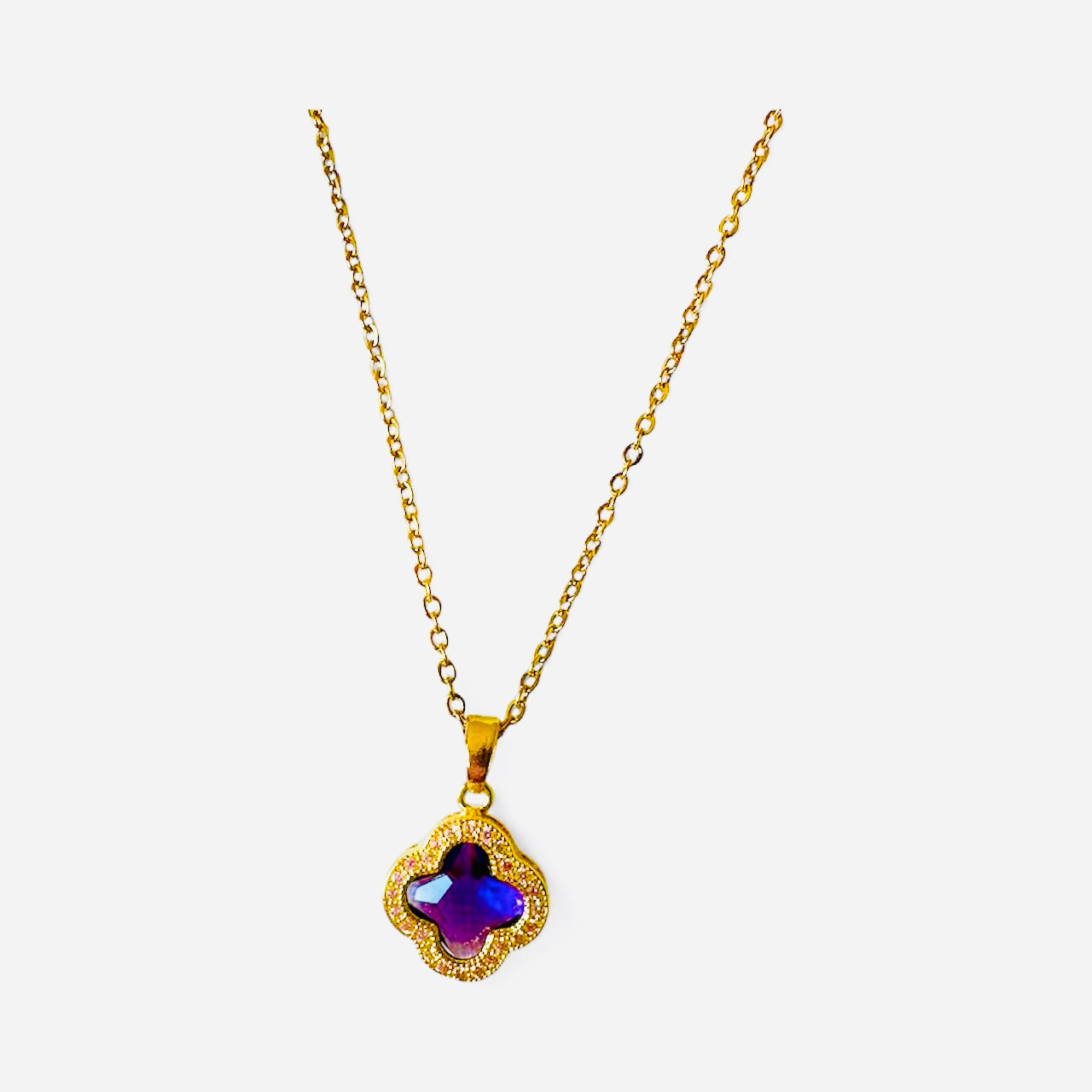 Gold necklace with a purple pendant with gold plated chain
