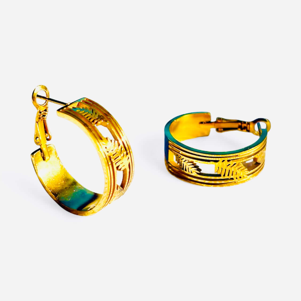 Close-up side view of 18K gold plated leaf engraved hoop earrings