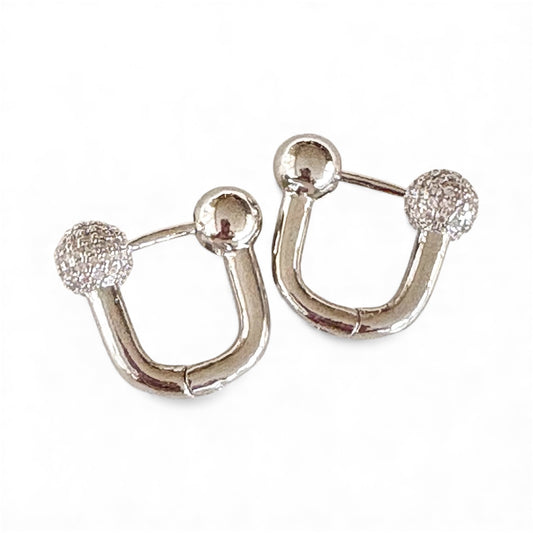 Front view of U‑shaped silver hoop earrings with polished and textured ball ends