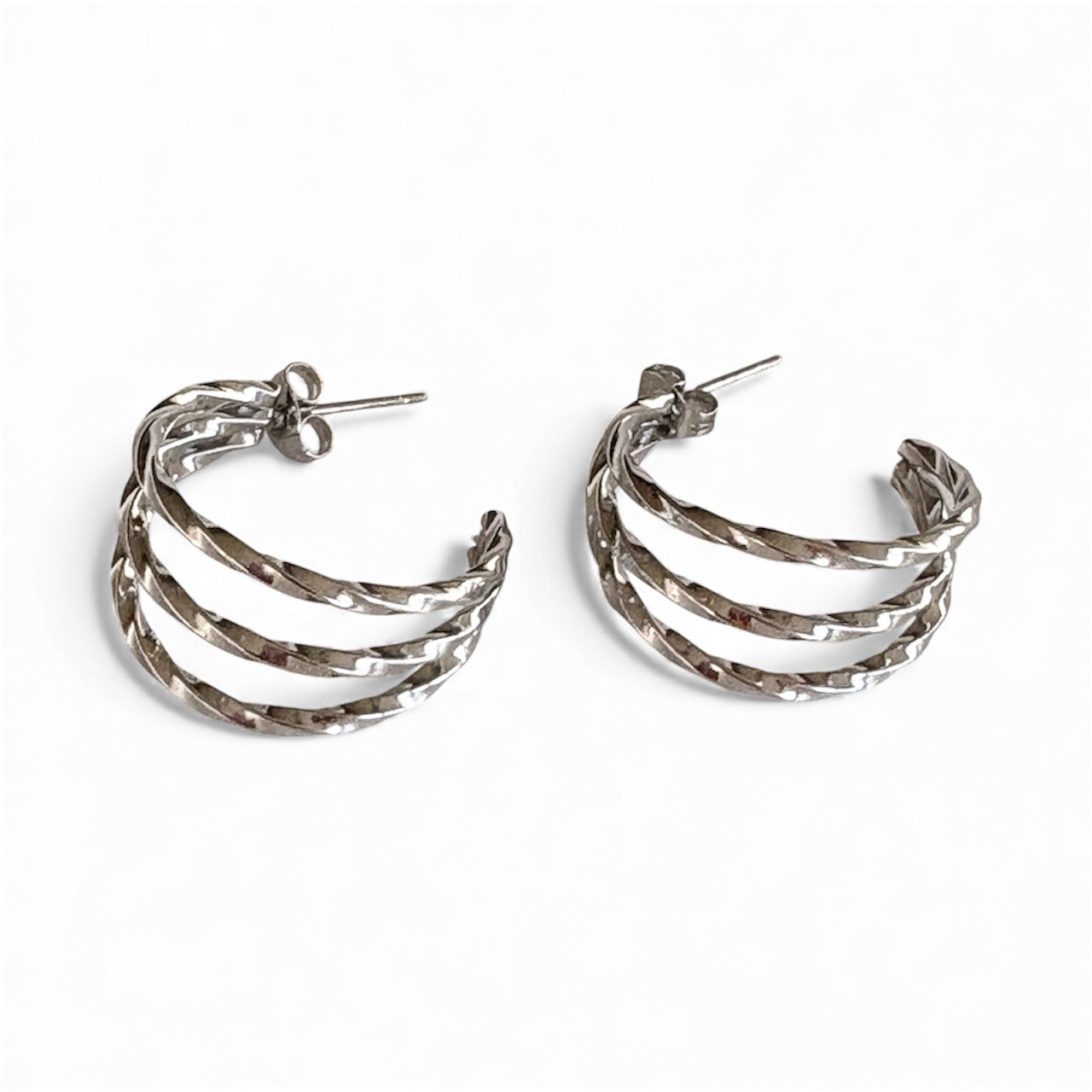 silver hammered triple‑band hoop earrings with a 2 cm diameter, showcasing layered bands and stud posts