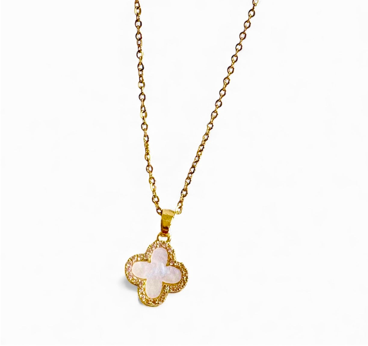 Gold necklace with a clover-shaped pendant on a white background