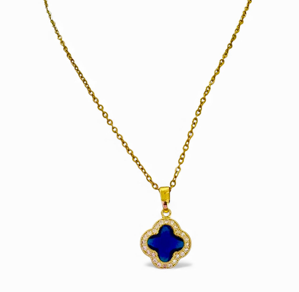 Gold necklace with a blue clover pendant on a white background