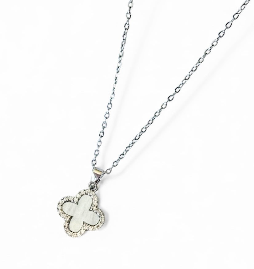 Butterfly-shaped pendant on a chain against a white background