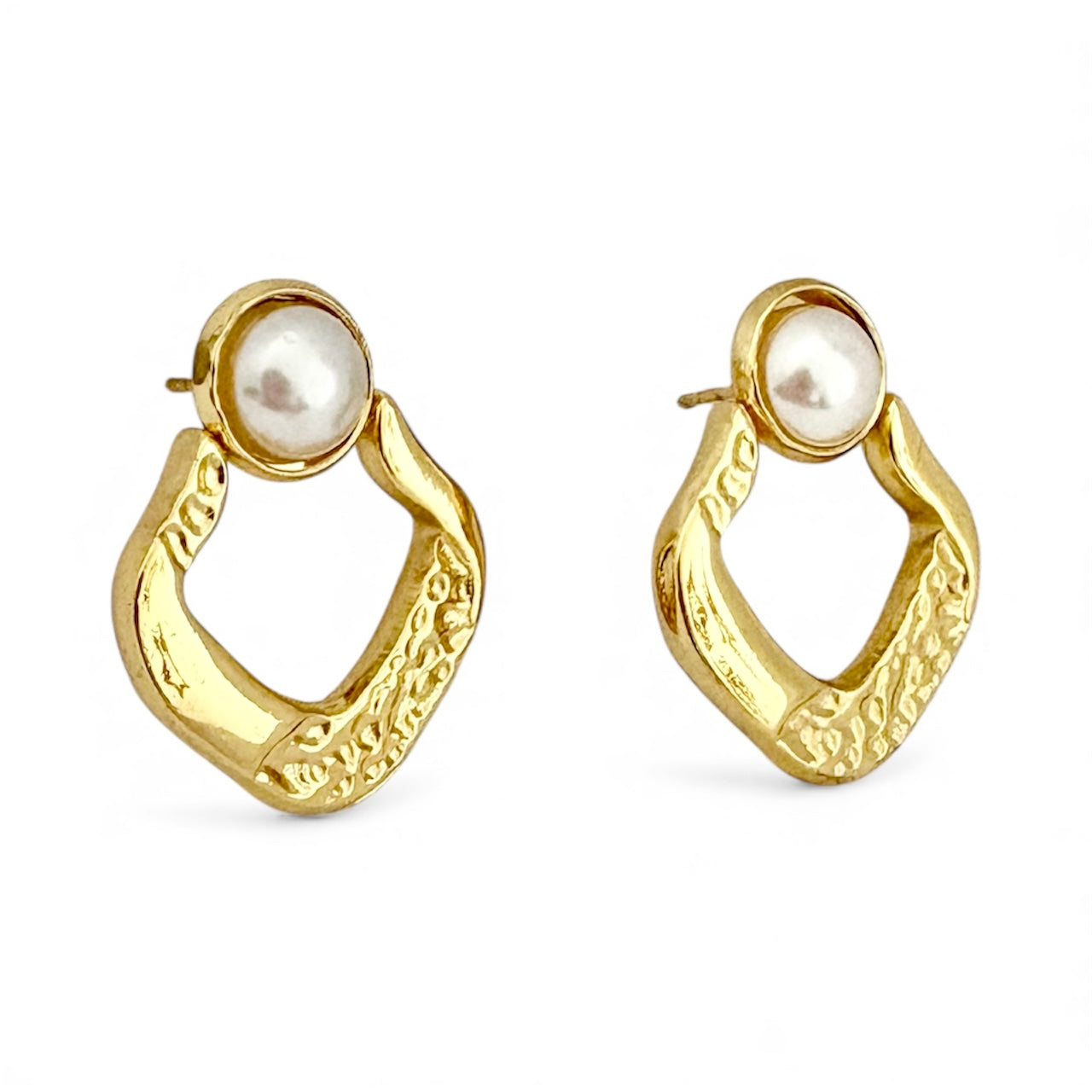 Gold hoop earrings with pearl centers on a white background