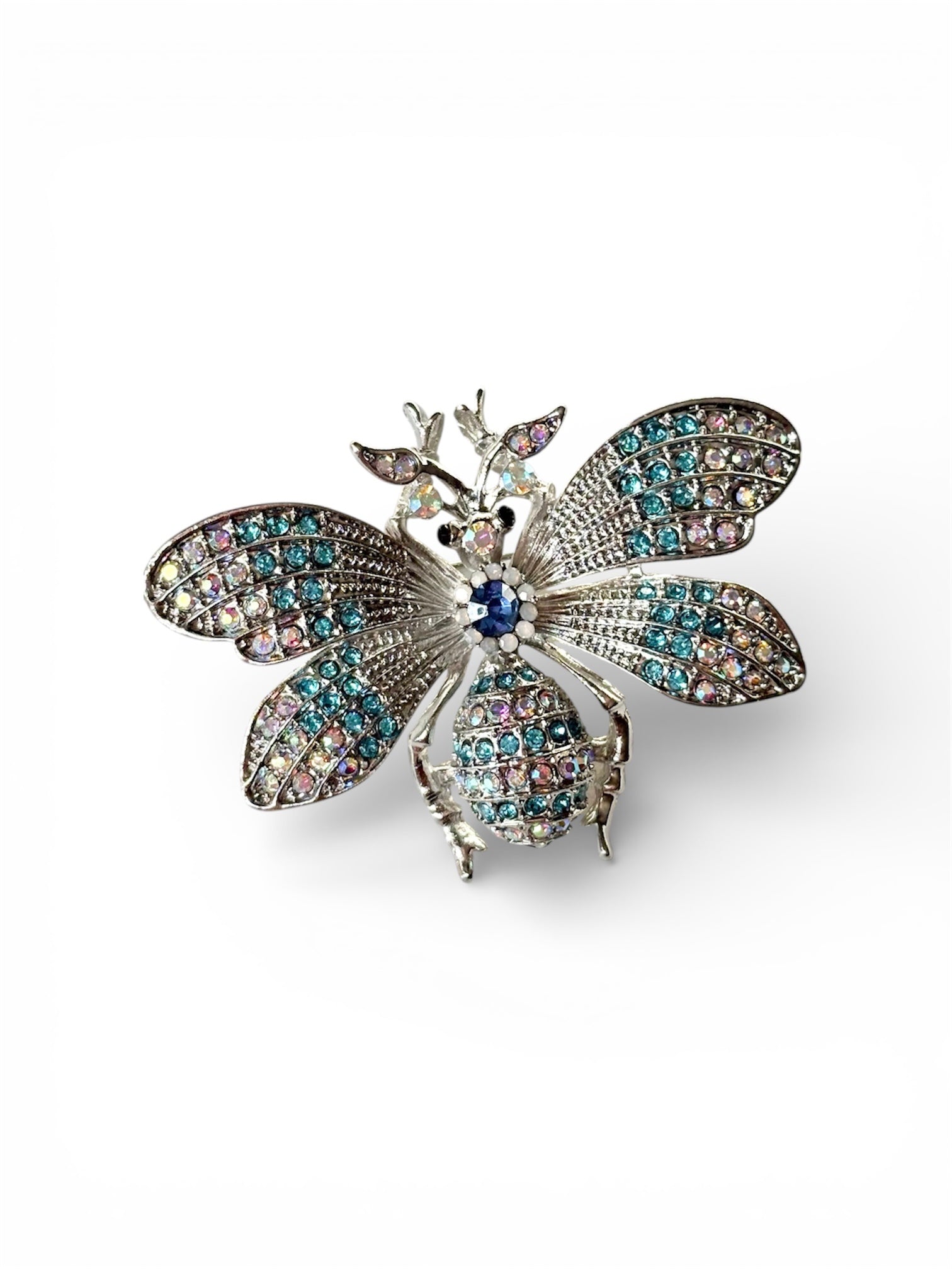 Decorative butterfly brooch with gemstones on a white background