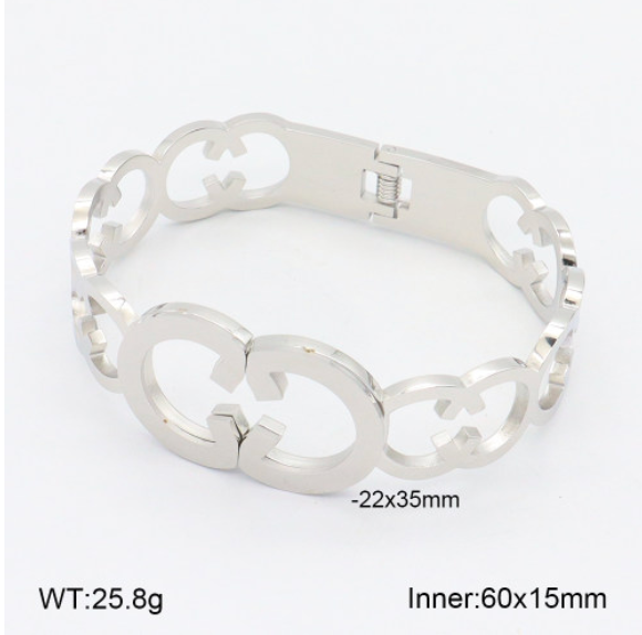 Silver bracelet with intricate design on a white background
