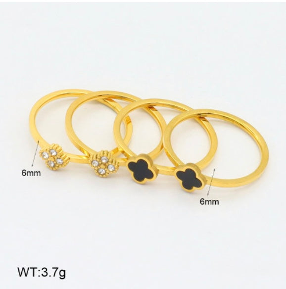 Four gold rings arranged on a white background
