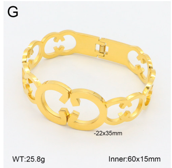 Gold bracelet with intricate design on a white background