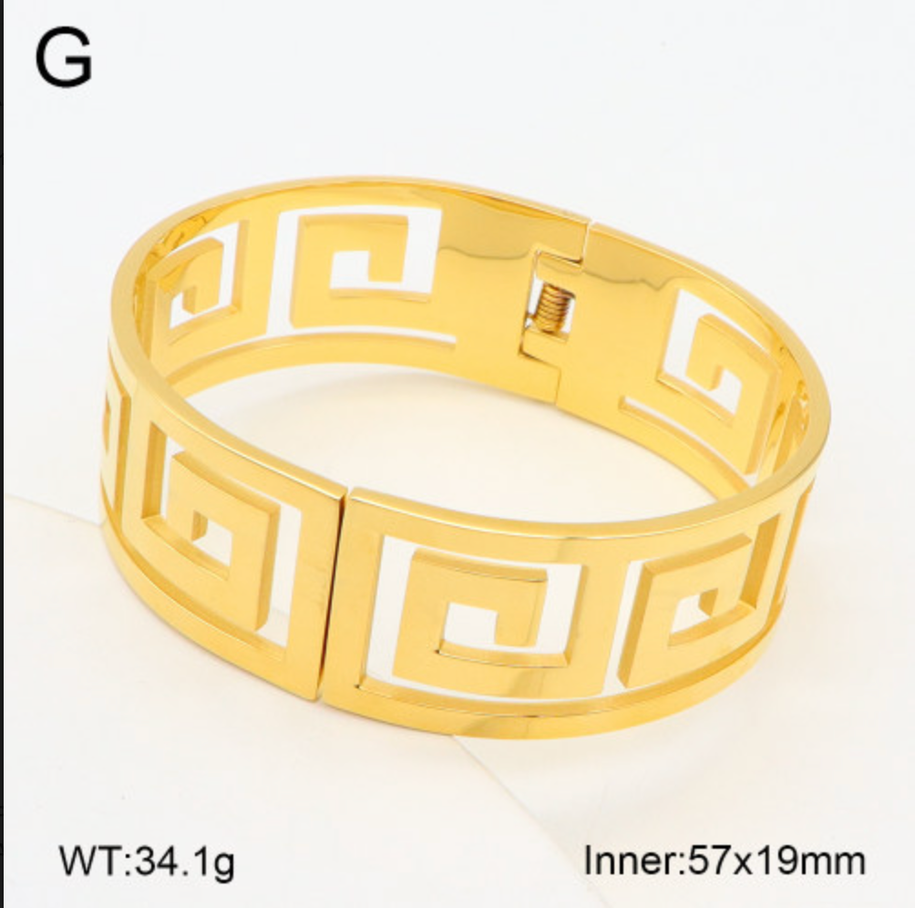 Gold bracelet with a geometric design on a white background