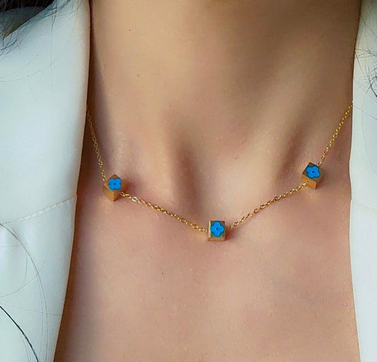 Gold Necklace with a blue flower cube