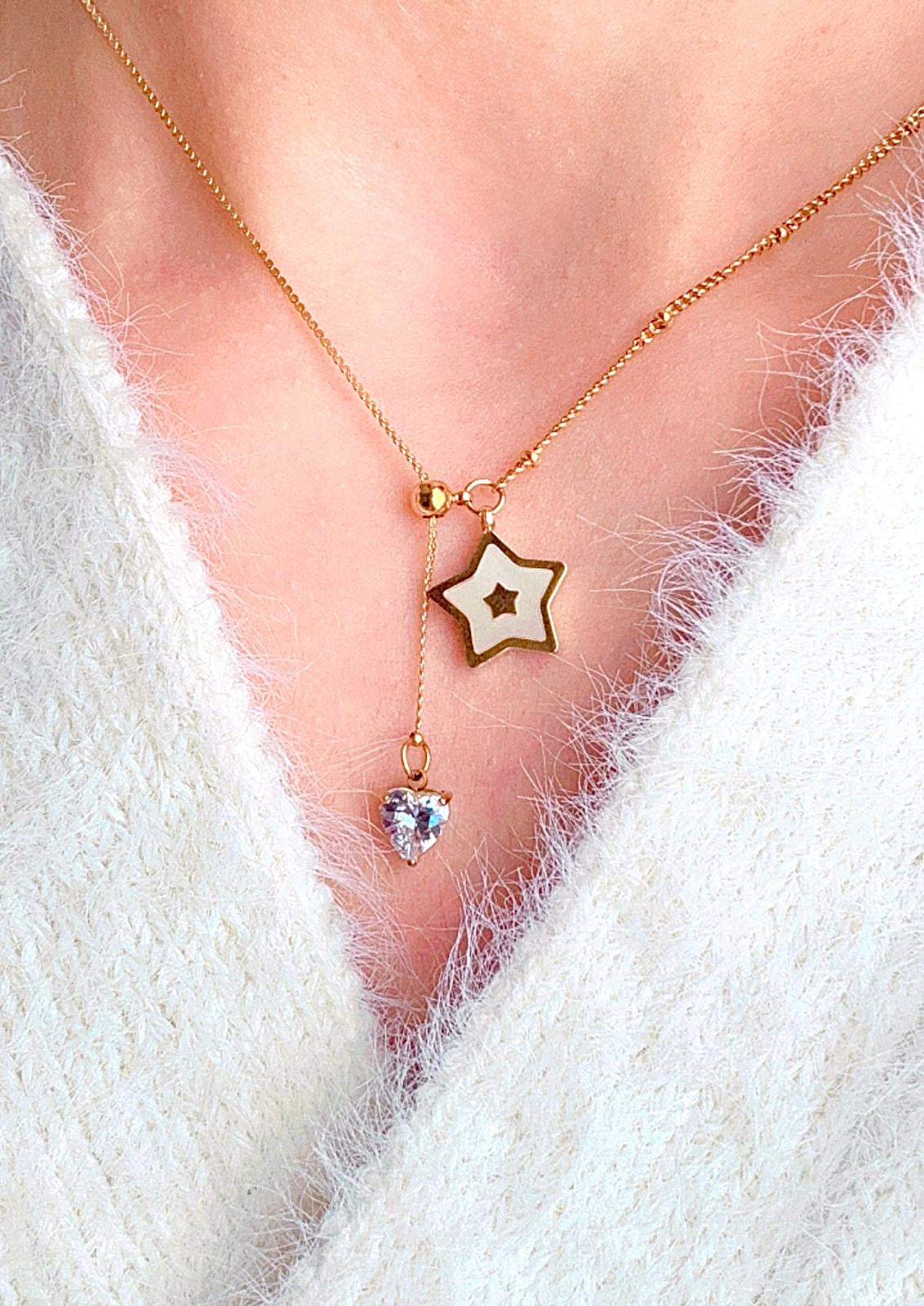Adjustable necklace with a star and heart pendant in gold color.